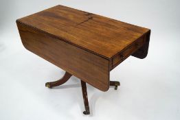 A George IV mahogany Pembroke table, having cutlery drawer to one end and opposing frieze drawer,