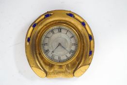 A Howell and James brass and enamel desk clock, in the form of a horseshoe,