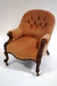 A Victorian walnut frame button back armchair, with scroll arms,