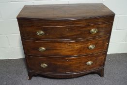 A 19th century mahogany bow front chest of three long drawers with shaped apron and splayed feet,