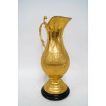 An Indian gilt metal ewer, the central body with hammered repeating design of a scholarly figure,