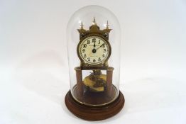 An early 20th century brass torsion clock, the dial signed M.H.