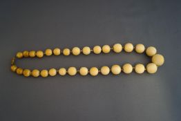 A graduated row of late Victorian ivory beads