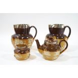 A pair of Royal Doulton saltglazed stoneware jugs, mounted with silver rims, 15cm high,