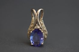 A tanzanite and diamond pendant, the white mount stamped Lonique and '18K', 2.