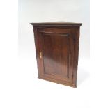 An 18th century oak hanging corner cupboard,