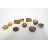 A collection of nine pill boxes,