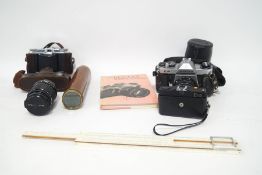 A Voigtlander Vito II camera in leather case, a Pentax Asahi KM camera with additional lens,