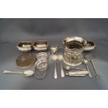 A set of three late Victorian silver salts; a silver bottle stand,