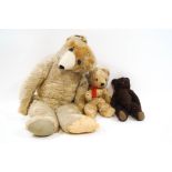 An early 20th century large teddy bear, together with two further bears,
