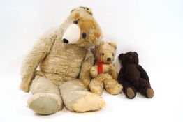 An early 20th century large teddy bear, together with two further bears,