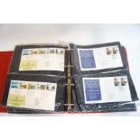 A stamp album containing World and British stamps, including two penny reds,