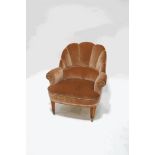 An early 20th century tub shaped chair with pink velvet and braided back on square tapering legs