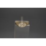 A four stone diamond ring, stamped '18ct', with pairs of single cuts to the shoulders,