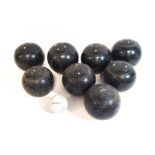 A set of turned ebony lawn bowls,