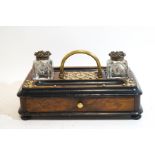 A Victorian walnut and ebonised inkstand with brass Gothic style mounts,