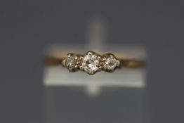 A three stone diamond ring, unmarked, finger size L, 2.