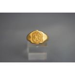 An 18 carat gold signet ring, monogrammed, 7.