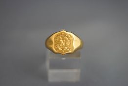 An 18 carat gold signet ring, monogrammed, 7.