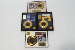 A collection of four 7" Elvis Presley gold plated records
