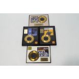 A collection of four 7" Elvis Presley gold plated records