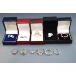 A collection of eleven silver and silver coloured stone set rings,