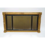 A Regency gilded sectional overmantel mirror, with pillar and block moulding,