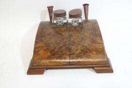 An Art Deco walnut desk ink stand with two glass inkwells and pen holders,