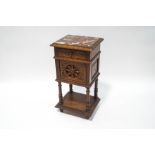A Victorian oak bedside cupboard with single drawer, profusely carved all over,