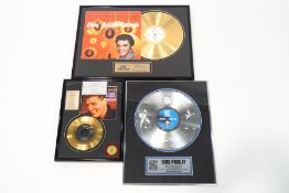 A collection of three Elvis Presley gold plated and silverized records,