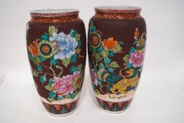 A pair of 20th century Chinese baluster vases, decorated with lions, lanterns and peonies,