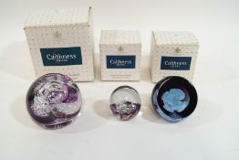 Two Caithness paperweights; 'Extravaganza', 'White Rose', and a Heron glass paperweight,