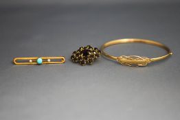 A 9 carat gold bangle; a turquoise and seed pearl bar brooch,