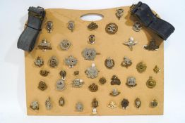 A collection of various military cap badges and a military cap,