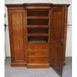 A Victorian mahogany breakfront triple wardrobe with one mirrored door opening to reveal four