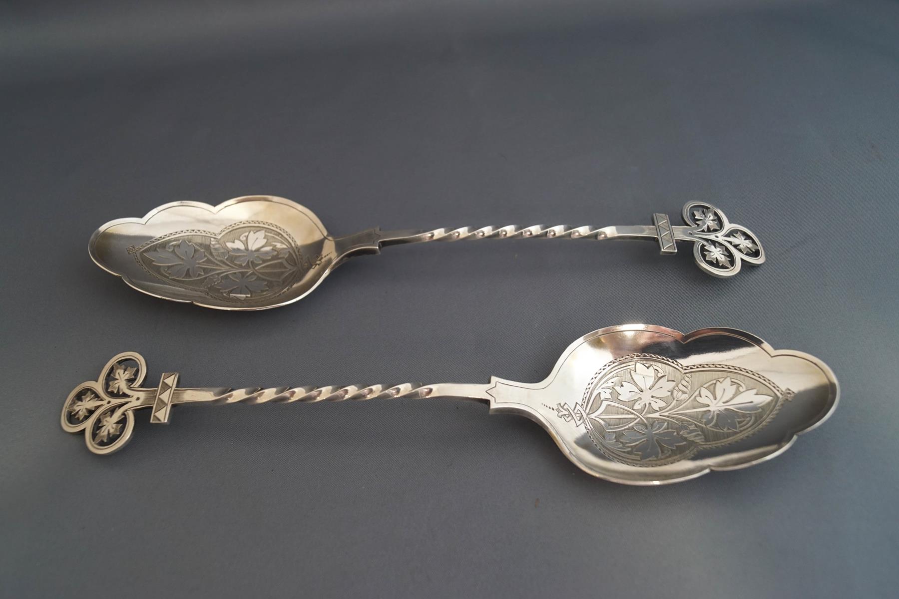 A pair of Victorian Gothic silver serving spoons, makers mark JAR, Sheffield 1872,