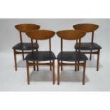 A set of four 1960's teak chairs with curved backs and black vinyl seats