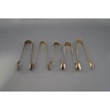 A collection of four silver sugar tongs; 63 g (2 troy ozs) gross;