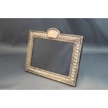 A rectangular photograph frame, marked 'Sterling', with arched cartouche top, 18.