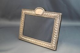 A rectangular photograph frame, marked 'Sterling', with arched cartouche top, 18.