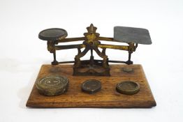 A set of Victorian brass postal scales and associated weights,