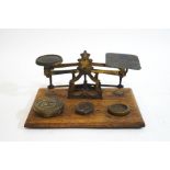 A set of Victorian brass postal scales and associated weights,