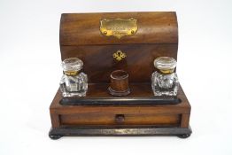 A Victorian rosewood desk set, comprising of enclosed arched letter rack, two glass inkwells,