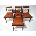 A set of four William IV mahogany carved bat back dining chairs,