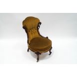 A Victorian rosewood button back nursing chair, with scroll frame and legs,