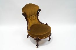 A Victorian rosewood button back nursing chair, with scroll frame and legs,