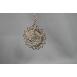 A Spink and Son pirate treasure coin, in a pendant mount and on a chain,