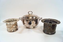 A pair of pierced silver plated wine coasters and a plated sauce warmer