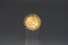 A 1909 sovereign in a 9 carat gold ring mount, 8.