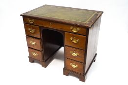 A George III and later mahogany kneehole desk, with green leather writing surface,